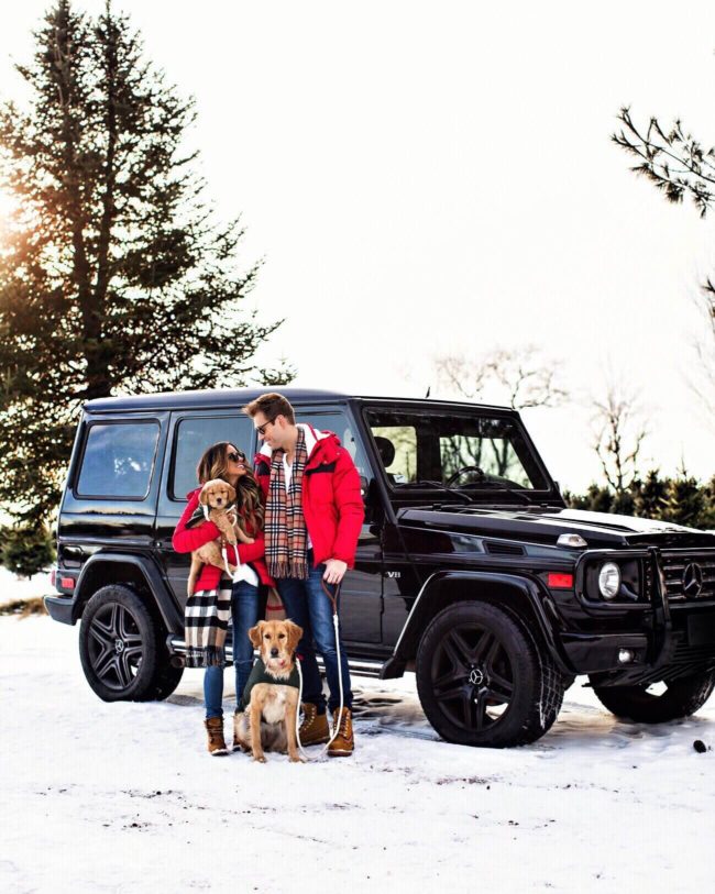 fashion blogger mia mia mine with husband and puppies in front of g wagon