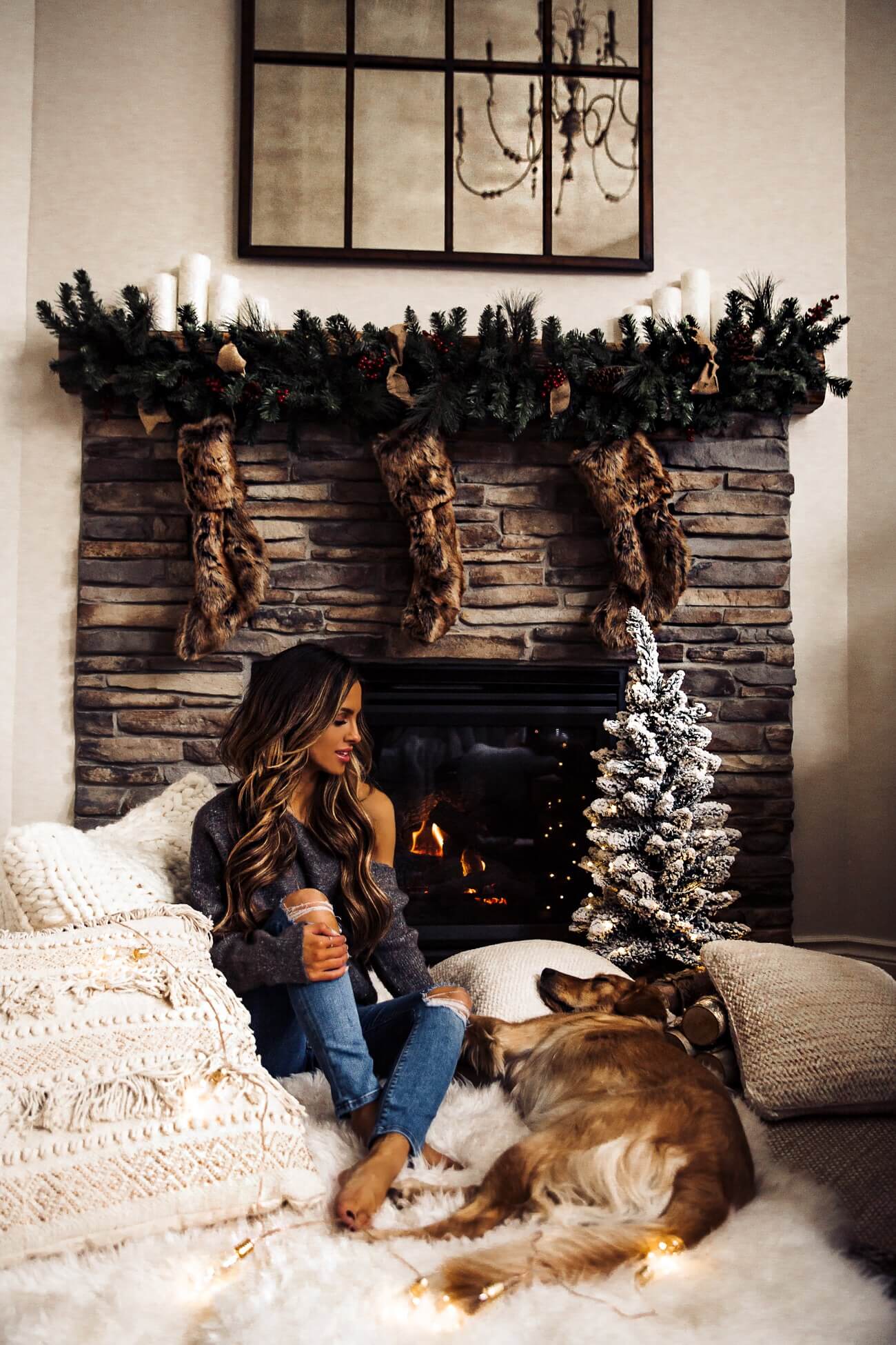fashion blogger mia mia mine and golden retriever by her fireplace