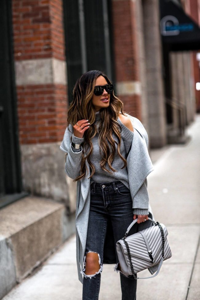 fashion blogger mia mia mine wearing a cold-shoulder gray sweater and a ysl college bag