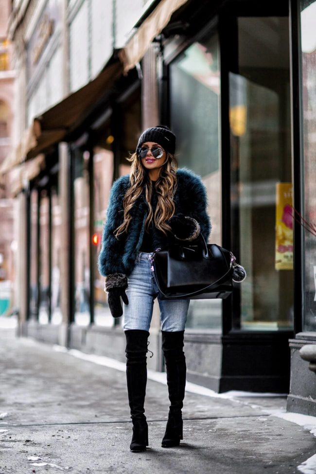fashion blogger mia mia mine wearing a faux fur jacket and stuart weitzman over-the-knee boots