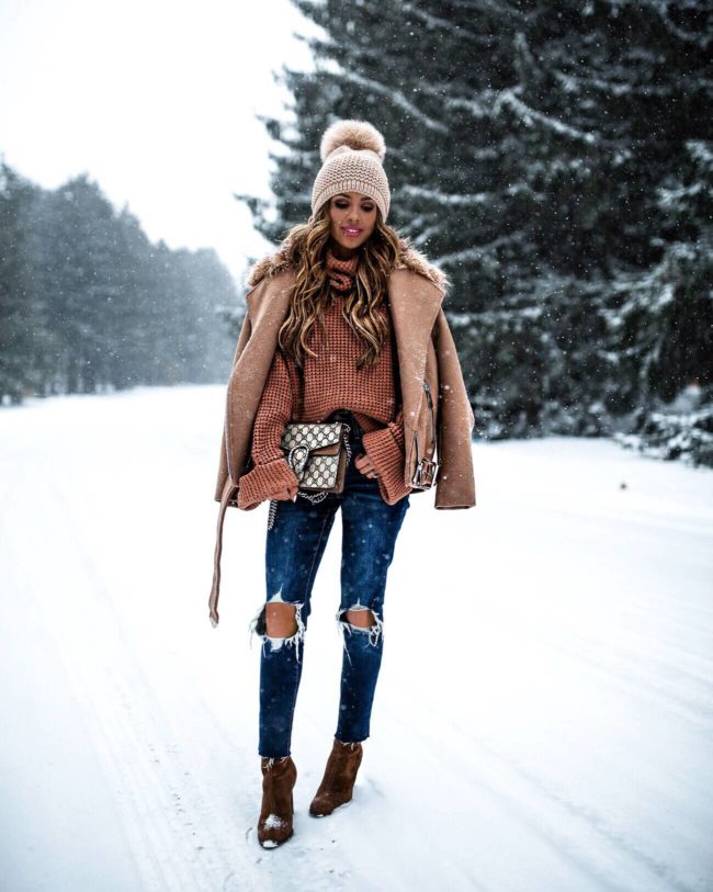 mia mia mine wearing a camel jacket and gucci dionysus bag in the snow