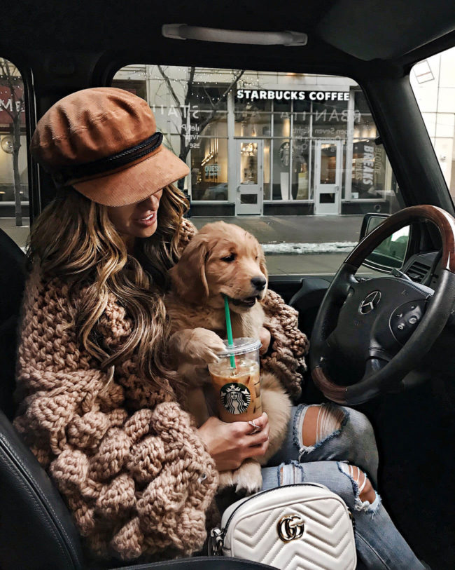mia mia mine wearing a chunky knit cardigan with golden retriever puppy