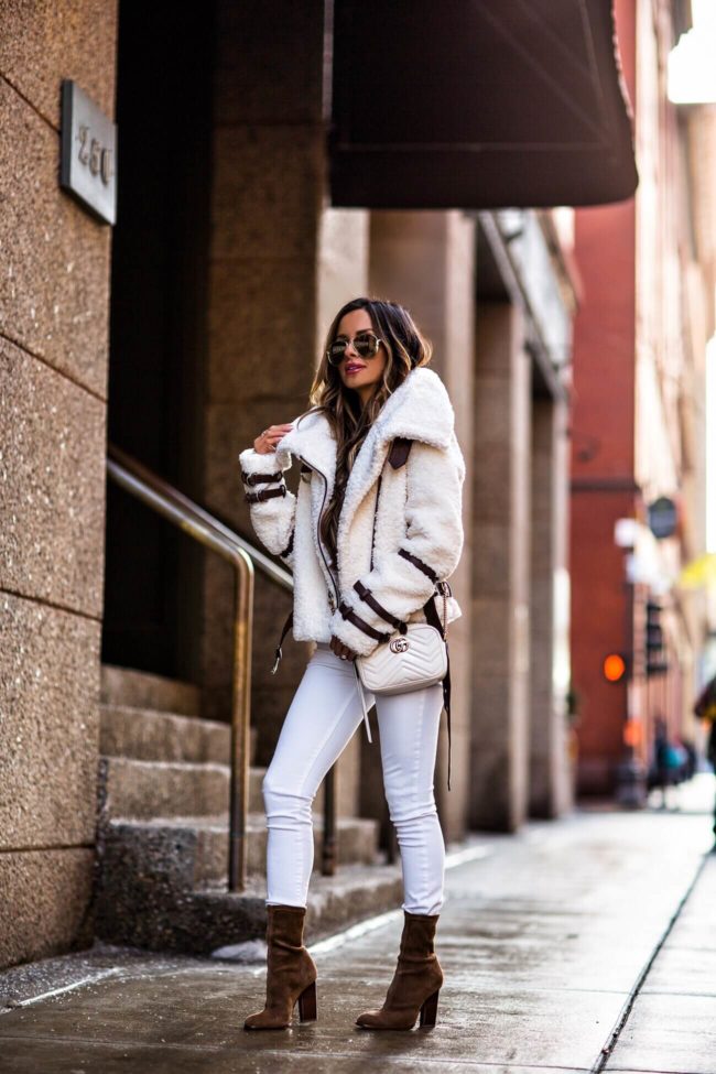 fashion blogger mia mia mine wearing a shearling jacket from revolve and a white gucci dionysus bag