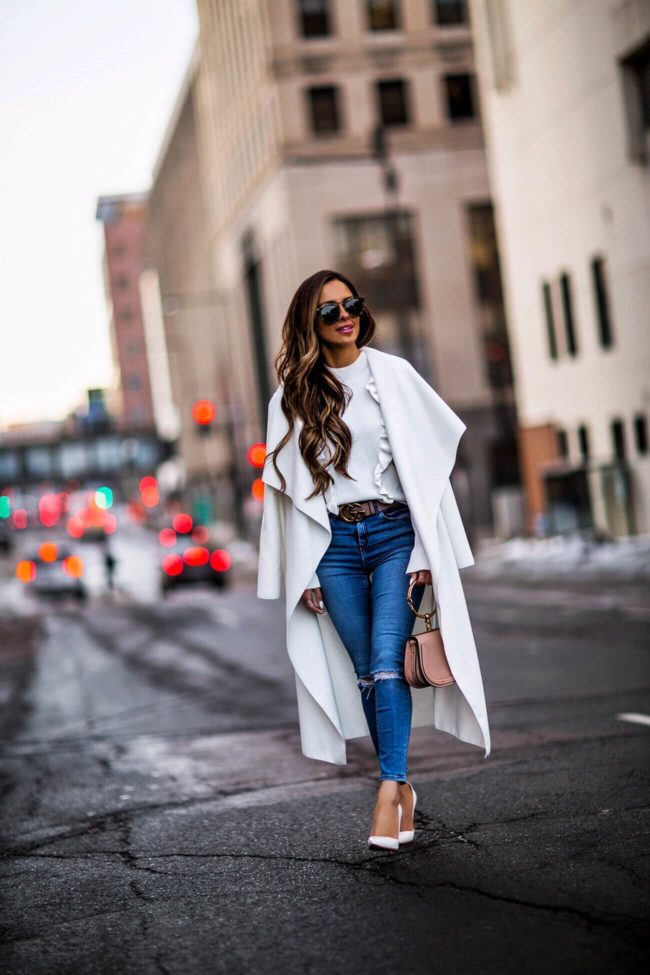 fashion blogger mia mia mine wearing a white coat with karen walker sunglasses