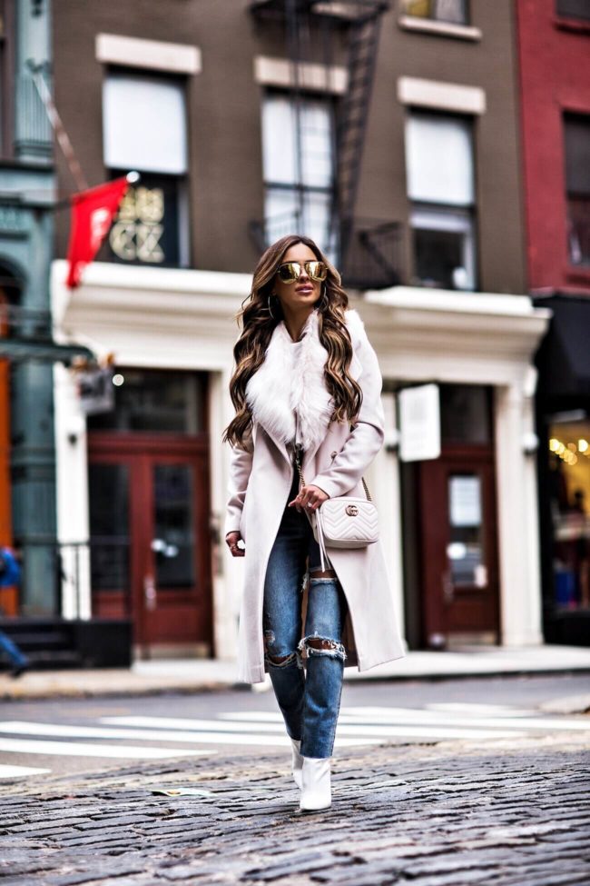 fashion blogger mia mia mine wearing an ivory faux fur coat from river island