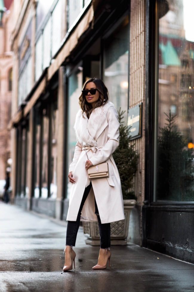 fashion blogger mia mia mine wearing a faux fur coat and ysl crossbody bag