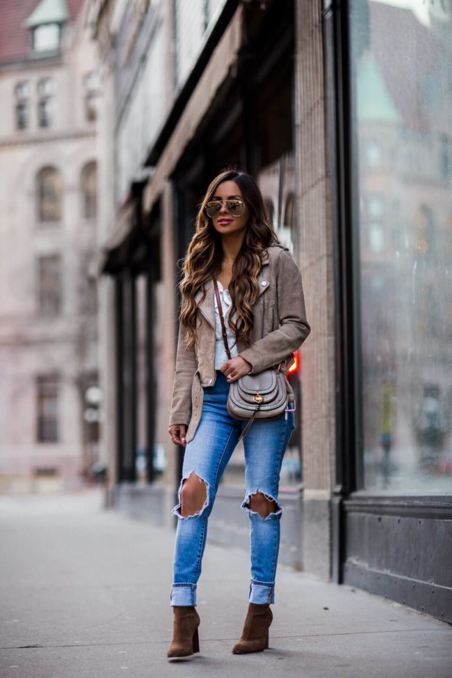 fashion blogger mia mia mine wearing a suede blank nyc moto jacket and a see by chloe leather bag
