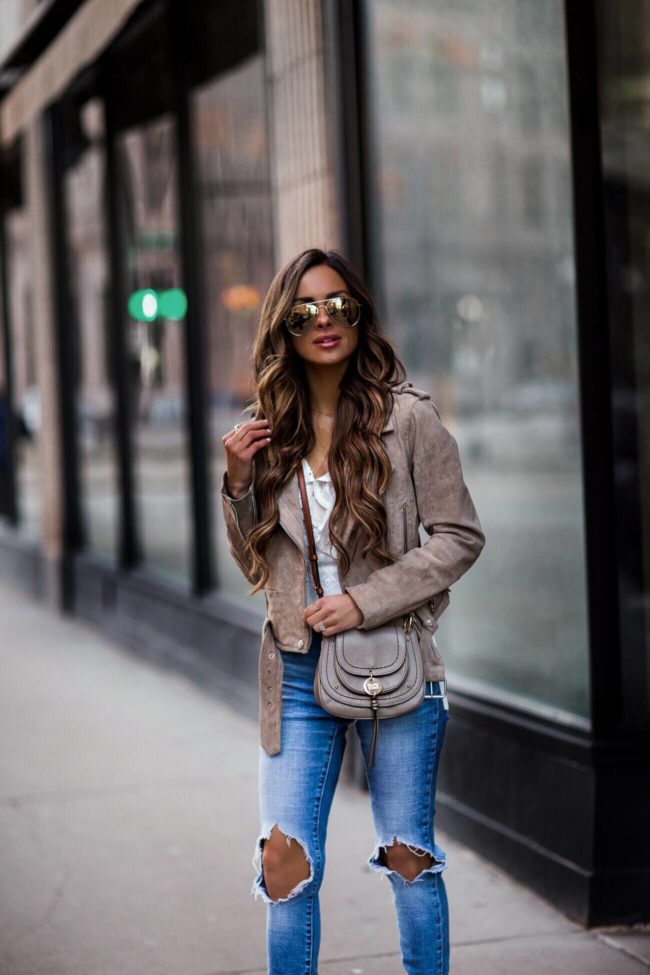 fashion blogger mia mia mine wearing a suede moto jacket and a see by chloe crossbody bag