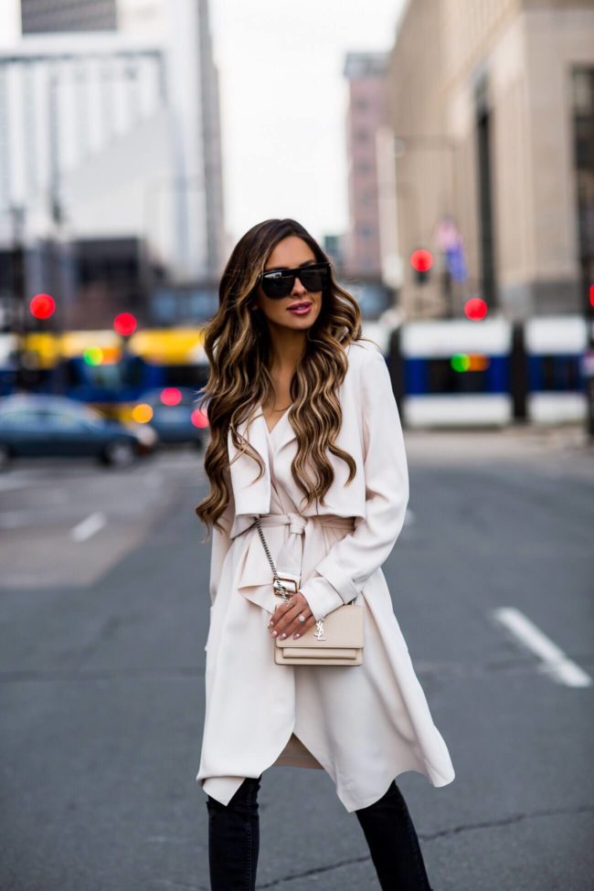 fashion blogger mia mia mine wearing a white trench coat from nordstrom and a saint laurent sunset bag