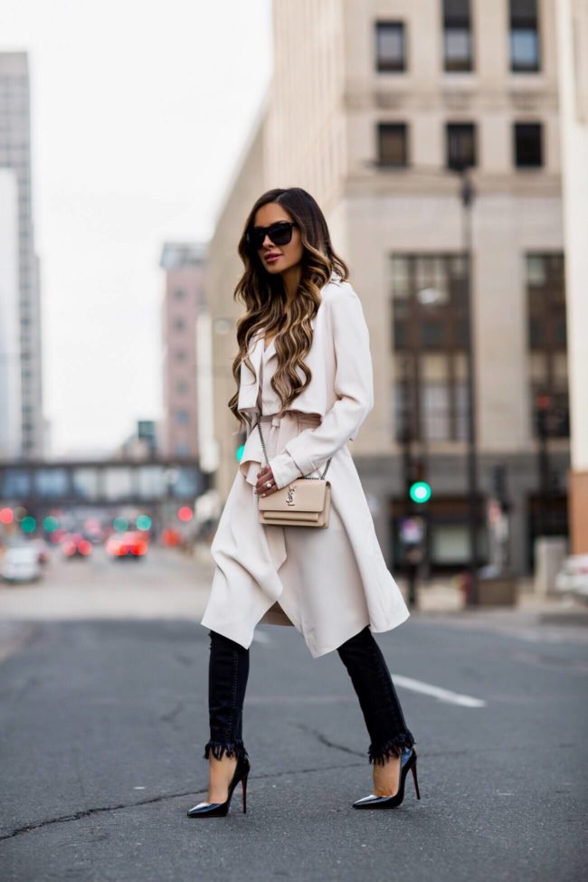 fashion blogger mia mia mine wearing an ivory trench and black fringe denim from nordstrom