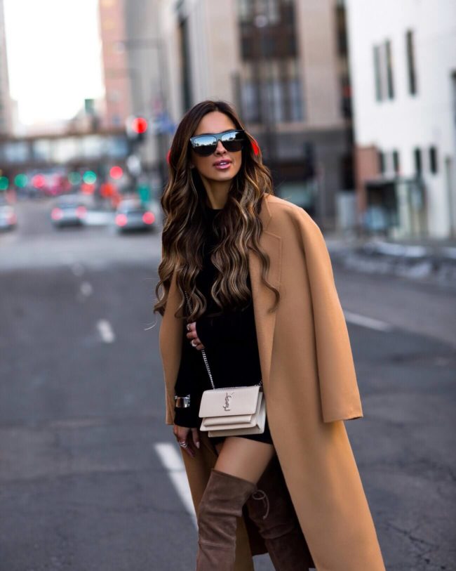 mia mia mine wearing a camel coat and brown suede over-the-knee boots
