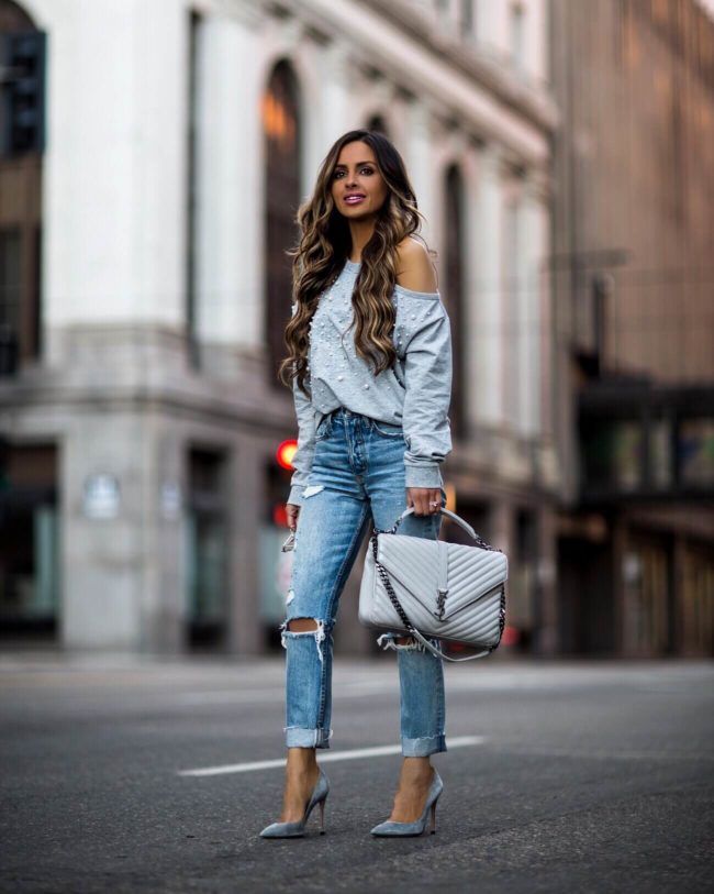 fashion blogger mia mia mine wearing a gray embellished sweatshirt from revolve