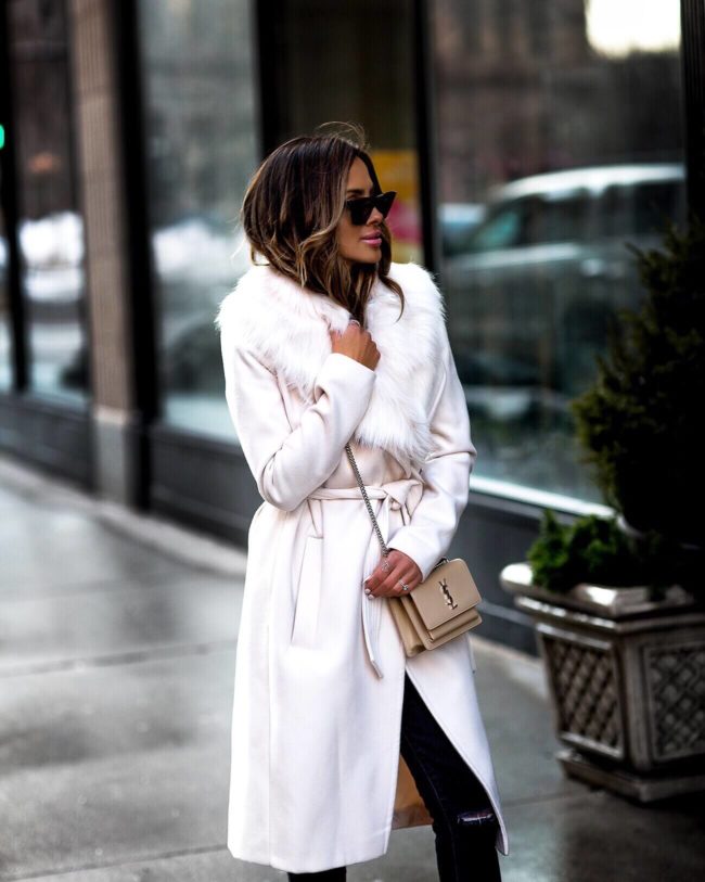 fashion blogger mia mia mine wearing an ivory faux fur coat and saint laurent sunet bag