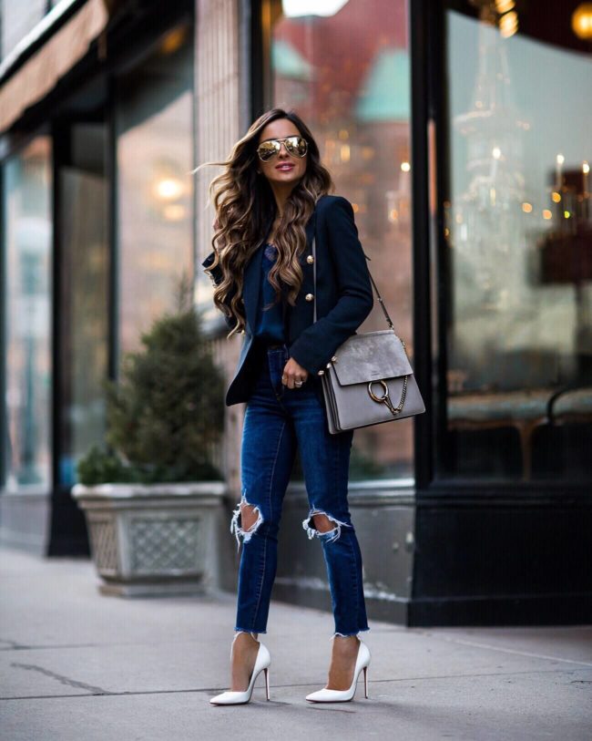 fashion blogger mia mia mine wearing a navy blazer and white louboutin heels