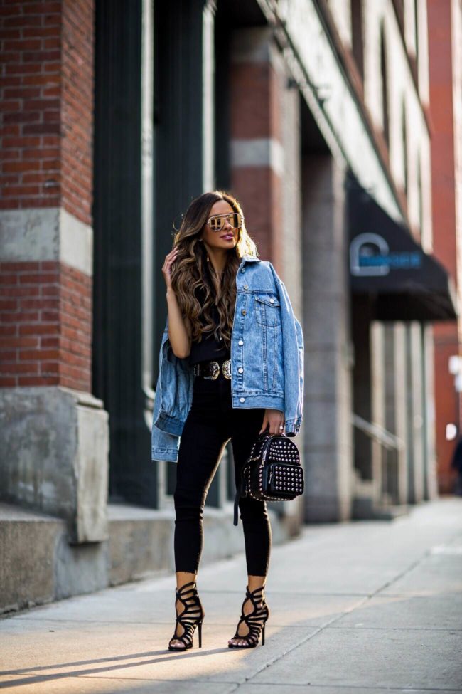 fashion blogger mia mia mine wearing a denim jacket and statement heels from missguided