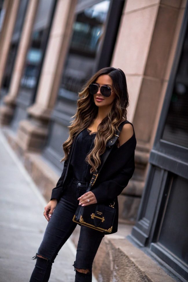 fashion blogger mia mia mine wearing a black lovers + friends blazer and black ripped skinny jeans from revolve