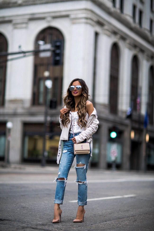 fashion blogger mia mia mine wearing a beige suede moto jacket and grlfrnd denim