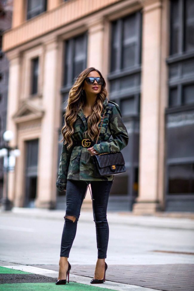 fashion blogger mia mia mine wearing a camo jacket and a chanel 2.55 bag