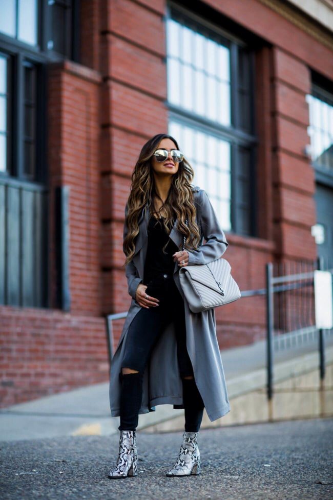 fashion blogger mia mia mine wearing a gray trench coat and grey saint laurent college bag