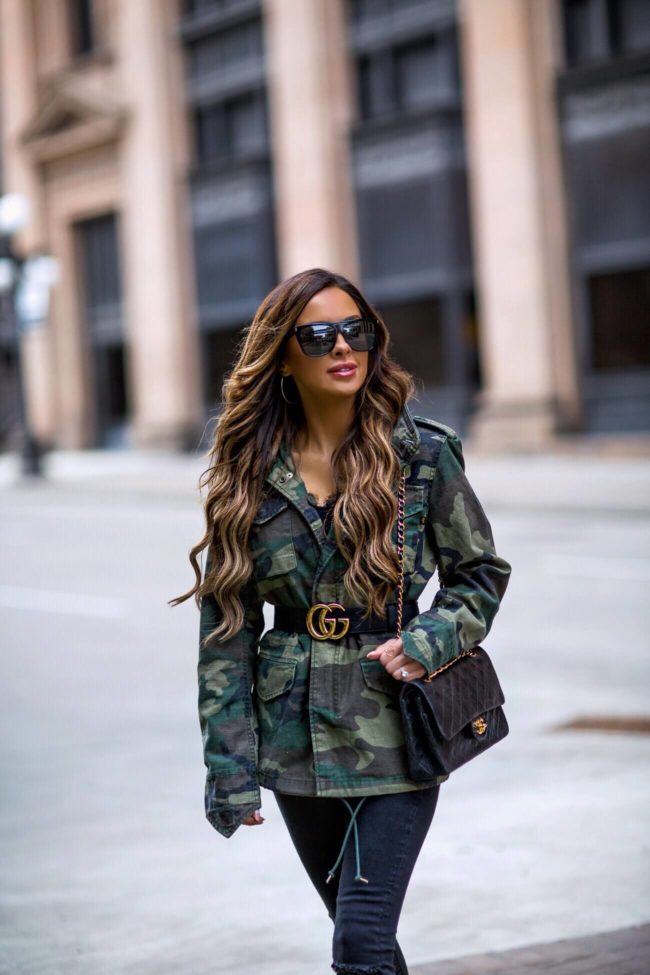 fashion blogger mia mia mine wearing a camo jacket and a gucci belt from net-a-porter