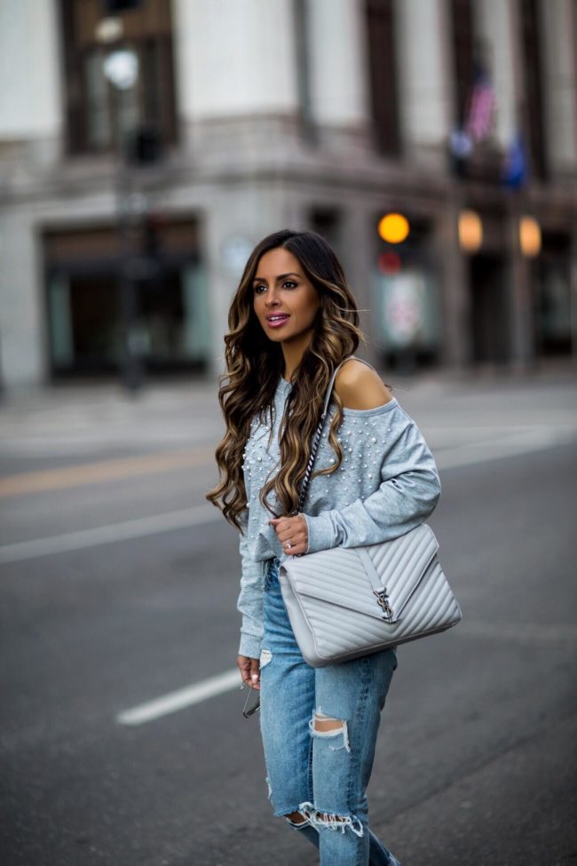 fashion blogger mia mia mine wearing a gray sweatshirt by olivia culpo and a saint laurent college bag