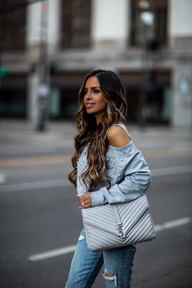 fashion blogger mia mia mine wearing a gray sweatshirt by olivia culpo and a saint laurent college bag
