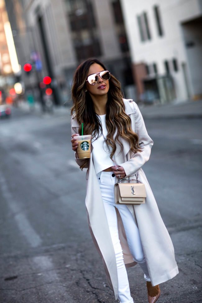 fashion blogger mia mia mine wearing a sunset crossbody bag and a nude trench coat from nordstrom