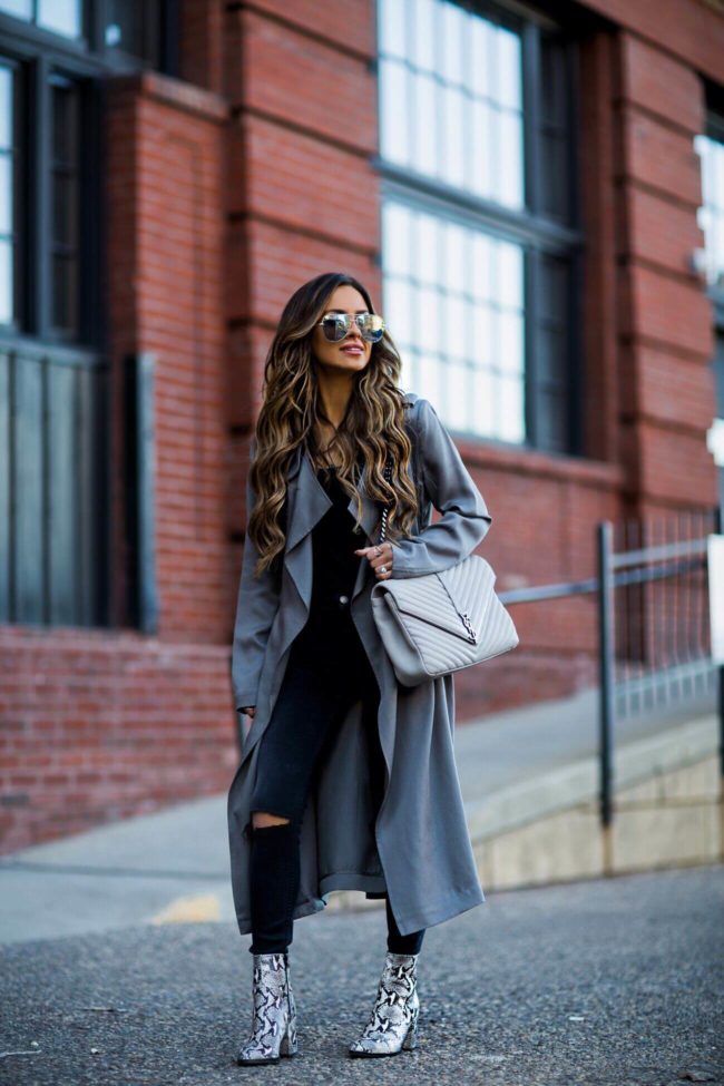 fashion blogger mia mia mine wearing black denim from revolve and snakeskin booties