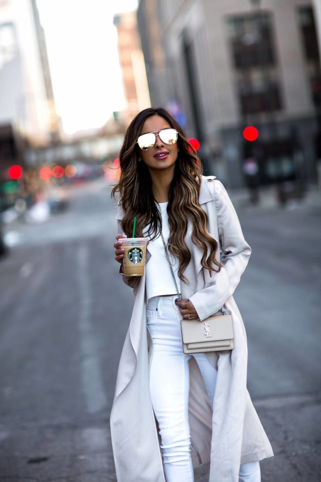 fashion blogger mia mia mine wearing a beige trench from nordstrom and a saint laurent mini sunset bag