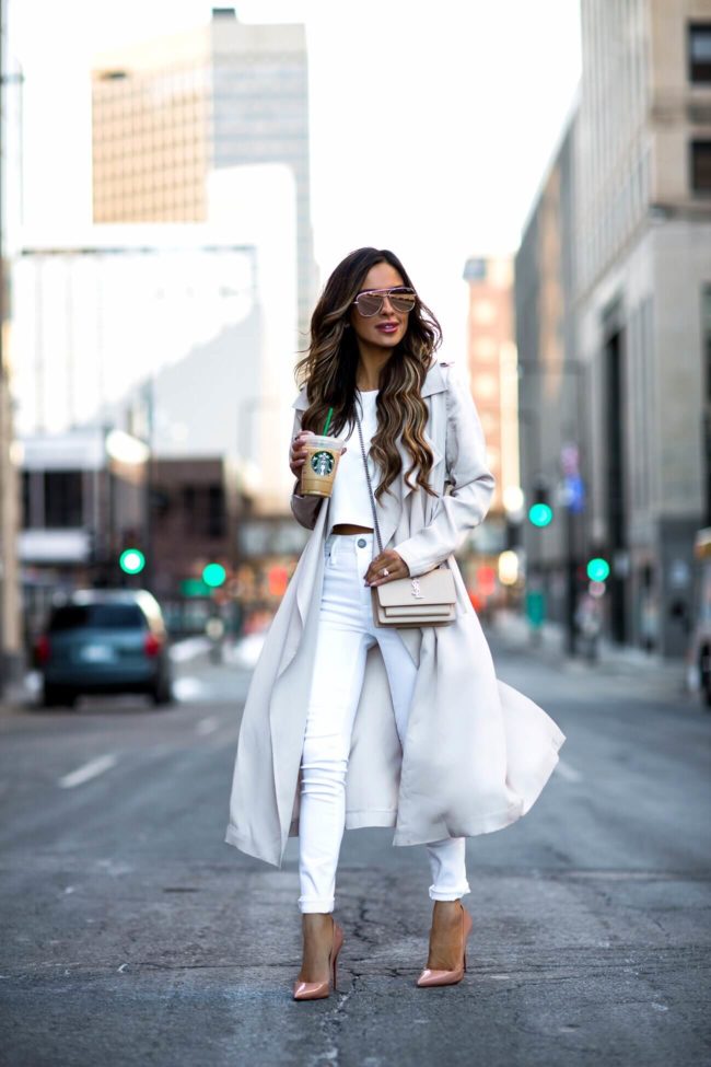 fashion blogger mia mia mine wearing a beige trench coat from nordstrom and a white crop top from club monaco