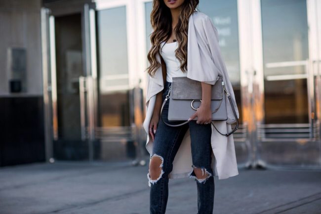 fashion blogger mia mia mine wearing a cupcakes and cashmere trench coat and a white bodysuit from revolve