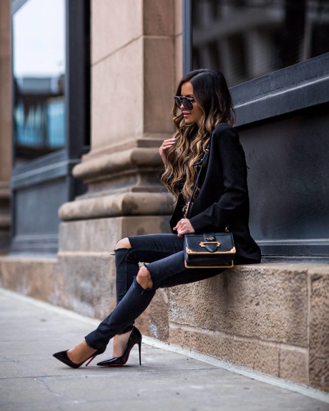 fashion blogger mia mia mine wearing a black blazer and a prada cahier bag