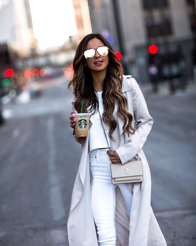 fashion blogger mia mia mine wearing a beige trench coat and a saint laurent sunset bag