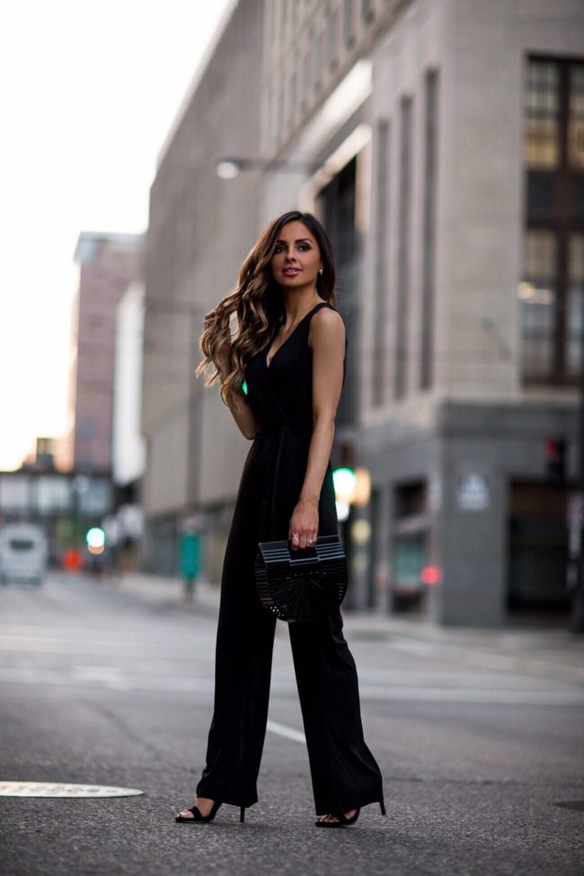 fashion blogger mia mia mine wearing a black ny collection petite jumpsuit from macy's