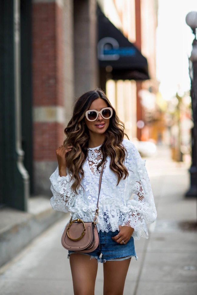 fashion blogger mia mia mine wearing a lace top from H&M and a chloe nile bag