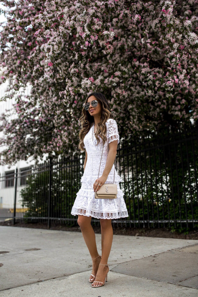 fashion blogger mia mia mine wearing a white lace dress from bloomingdale's