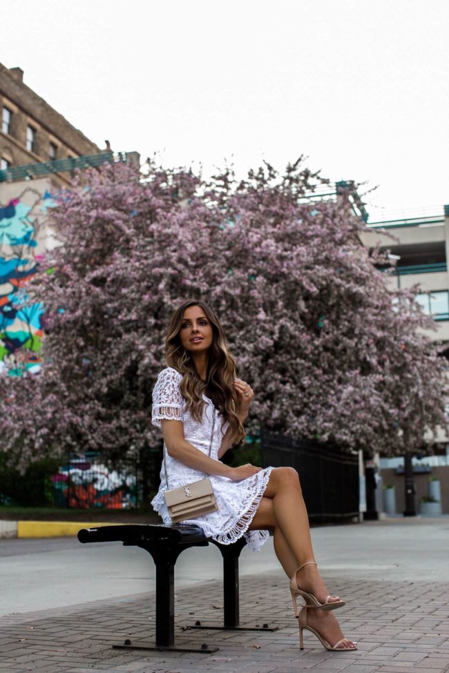 fashion blogger mia mia mine wearing a white lace french connection dress from bloomingdale's