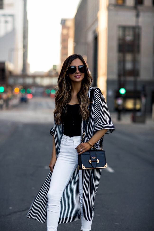 fashion blogger mia mia mine wearing a striped top and a prada cahier bag