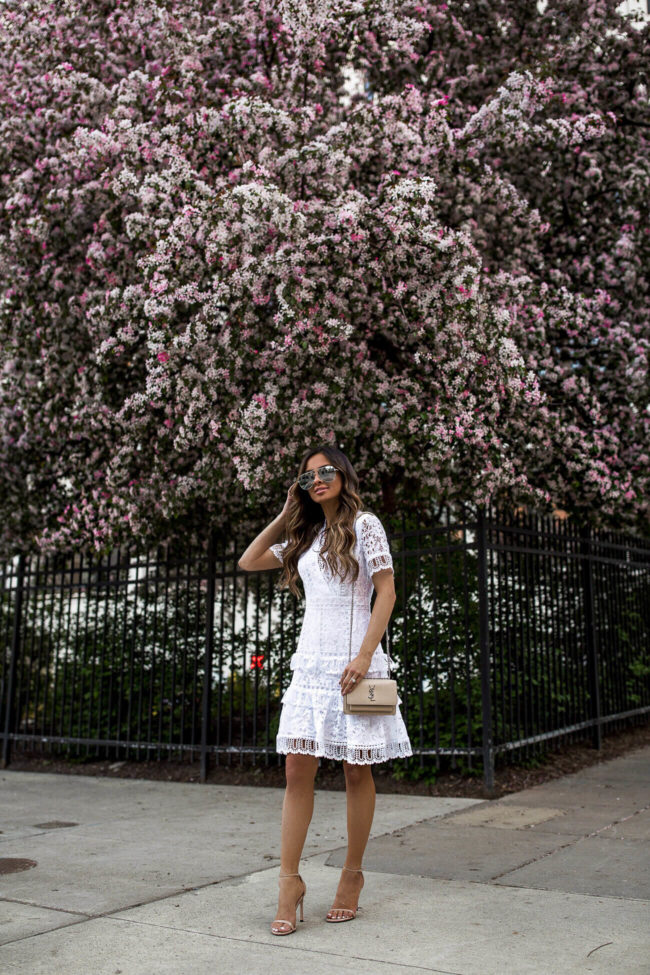 fashion blogger mia mia mine wearing a white lace french connection dress and stuart weitzman nudist heels