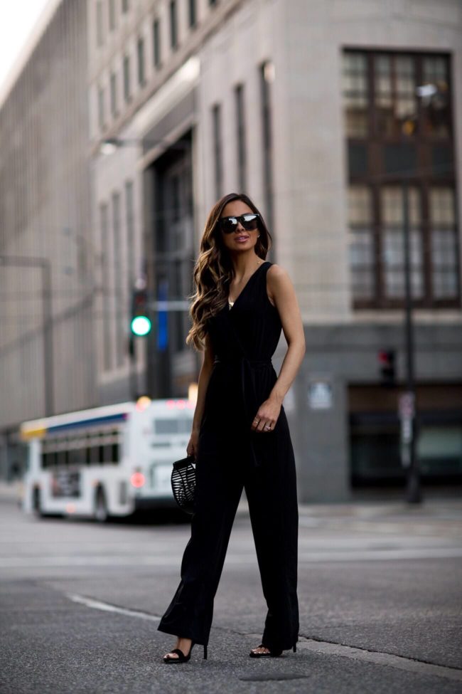 fashion blogger mia mia mine wearing a black petite jumpsuit from macy's