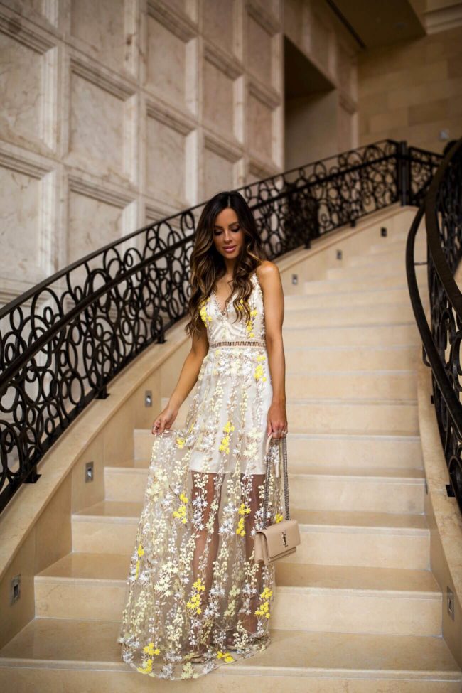 fashion blogger mia mia mine wearing a yellow wedding guest dress from bloomingdale's