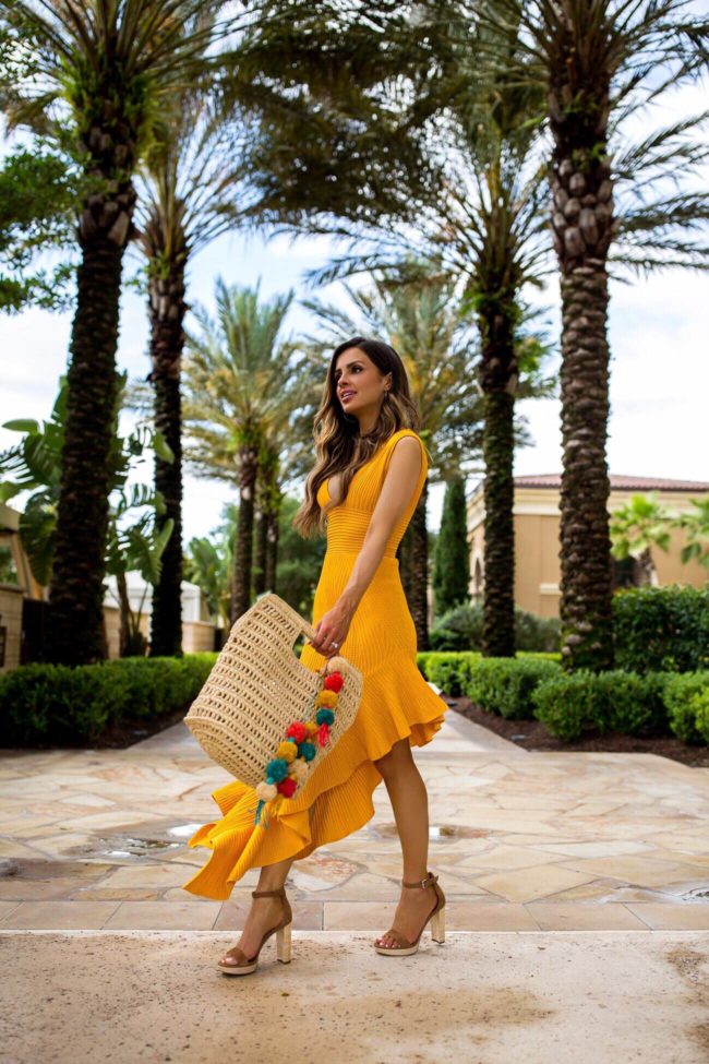 fashion blogger mia mia mine wearing a yellow dress in orlando florida