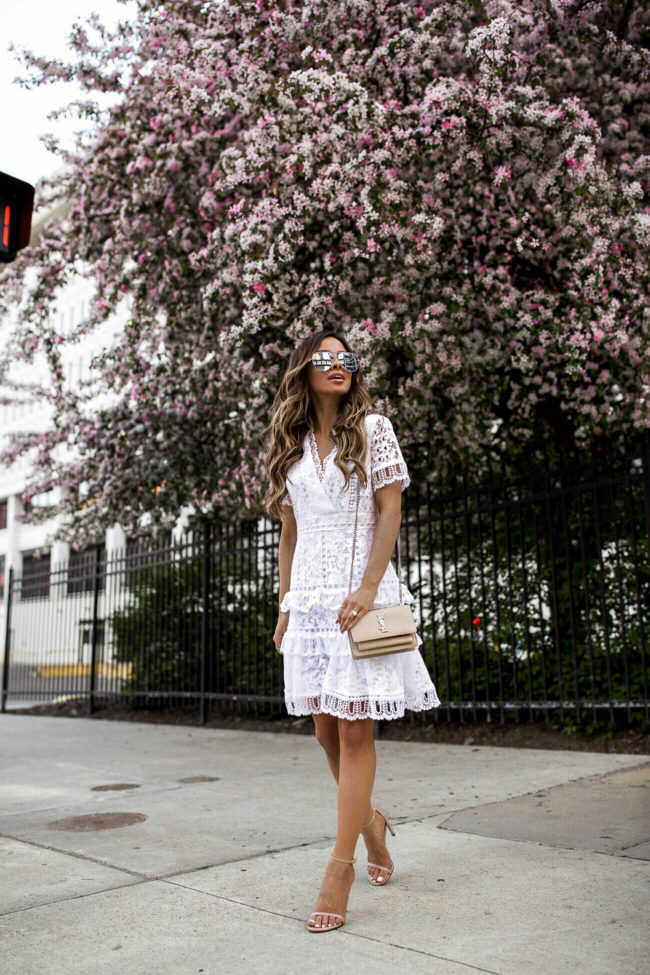 fashion blogger mia mia mine wearing a white lace french connection dress for spring 2018