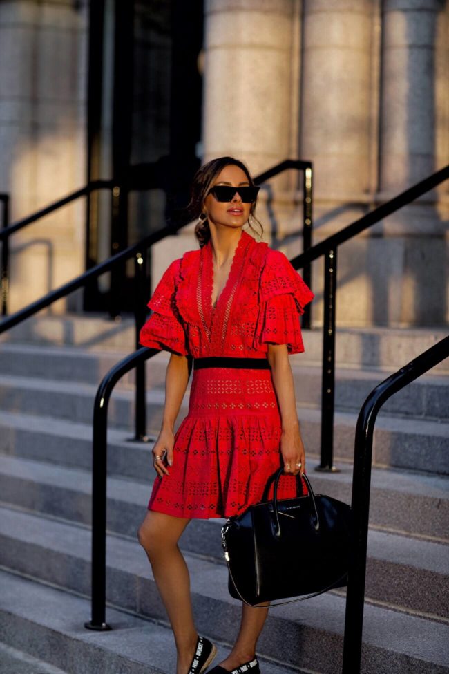 fashion blogger mia mia mine wearing a red lace dress by self portrait from harvey nichols