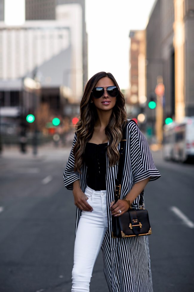 fashion blogger mia mia mine wearing a free people bodysuit and a striped cover-up