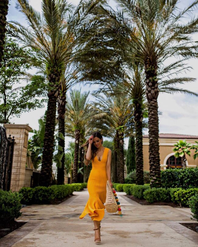 fashion blogger mia mia mine wearing a yellow dress from revolve