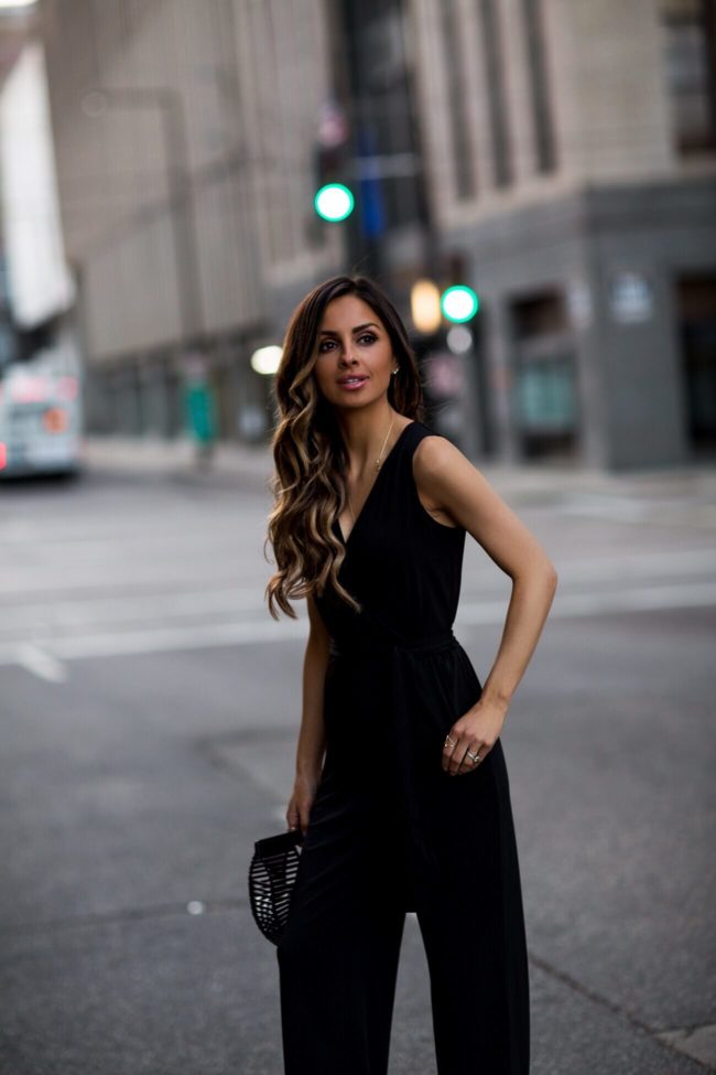 fashion blogger mia mia mine wearing a black jumpsuit from macy's