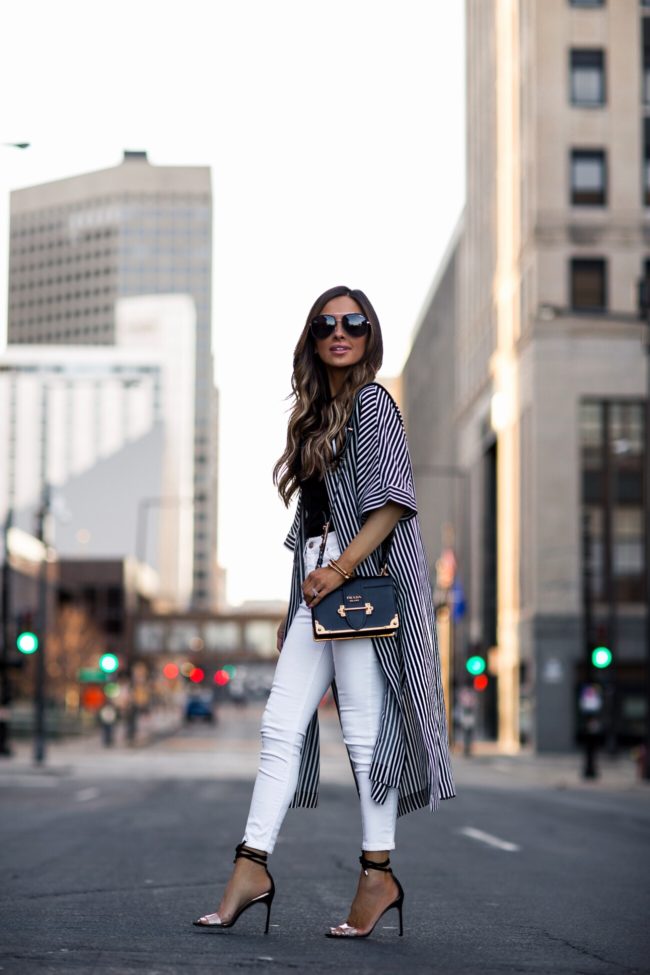 fashion blogger mia mia mine wearing a striped jacket and a prada cahier bag