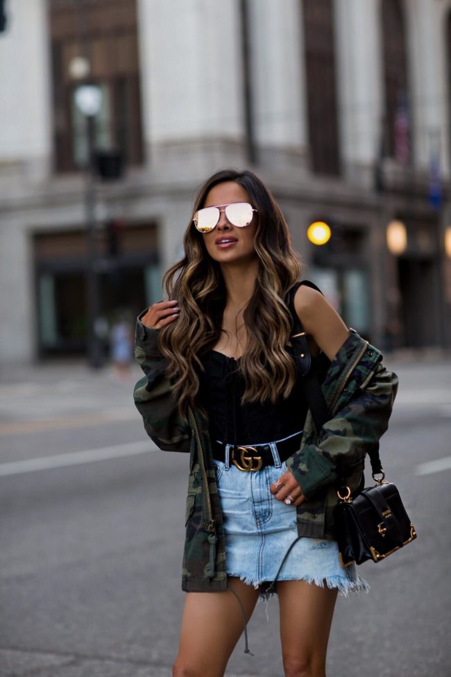 fashion blogger mia mia mine wearing a gucci double g buckle belt and a camo alpha industries jacket from shopbop