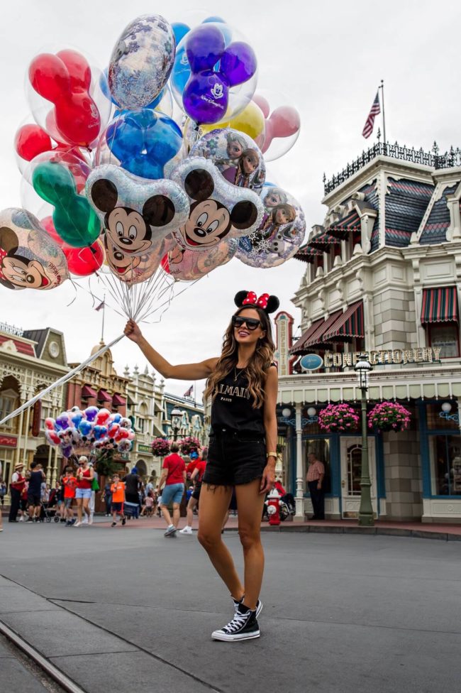 fashion blogger mia mia mine wearing a casual outfit at disney world